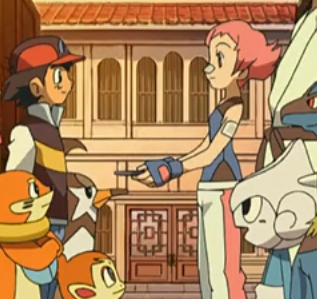 A screenshot from the Pokemon anime, showing Gym Leader Maylene presenting Ash with a badge