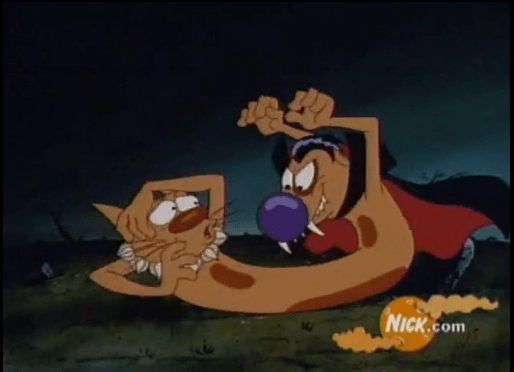 A scene from the Halloween episode of _CatDog_, featuring Cat being confronted by a vampire Dog, who has fangs and a cape, in a dark, spooky setting.