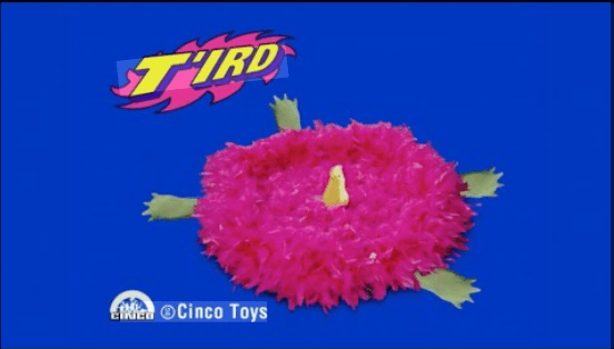 A disc covered with pink feathers, with a yellow beak emerging from the top, and green tortoise legs poking out from the sides